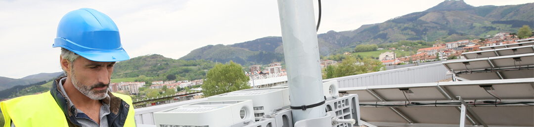 A worker studies a rooftop solar array