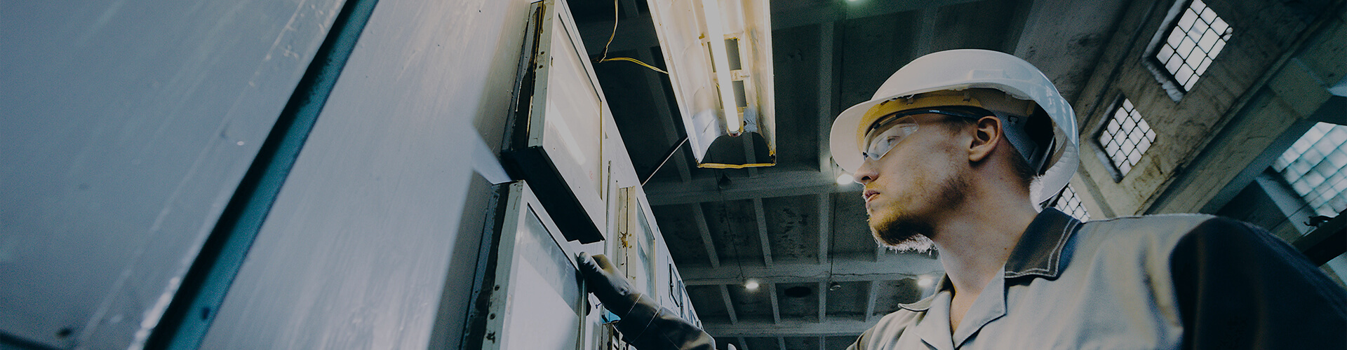 A worker examines some equipment in a power plant.