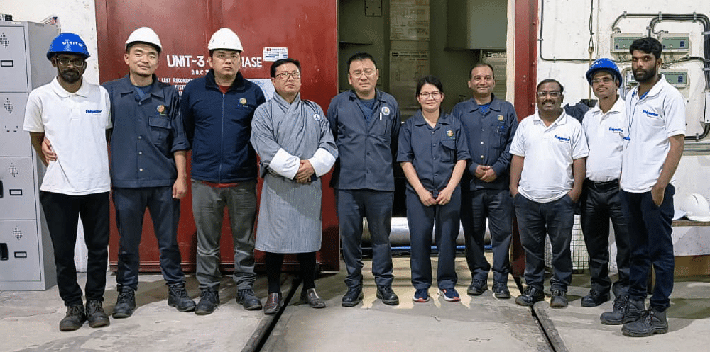 Workers at a remote hydroelectric powerplant in Bhutan standing with the team from LeakExpert in India who came with the solution of Polywater PowerPatch.